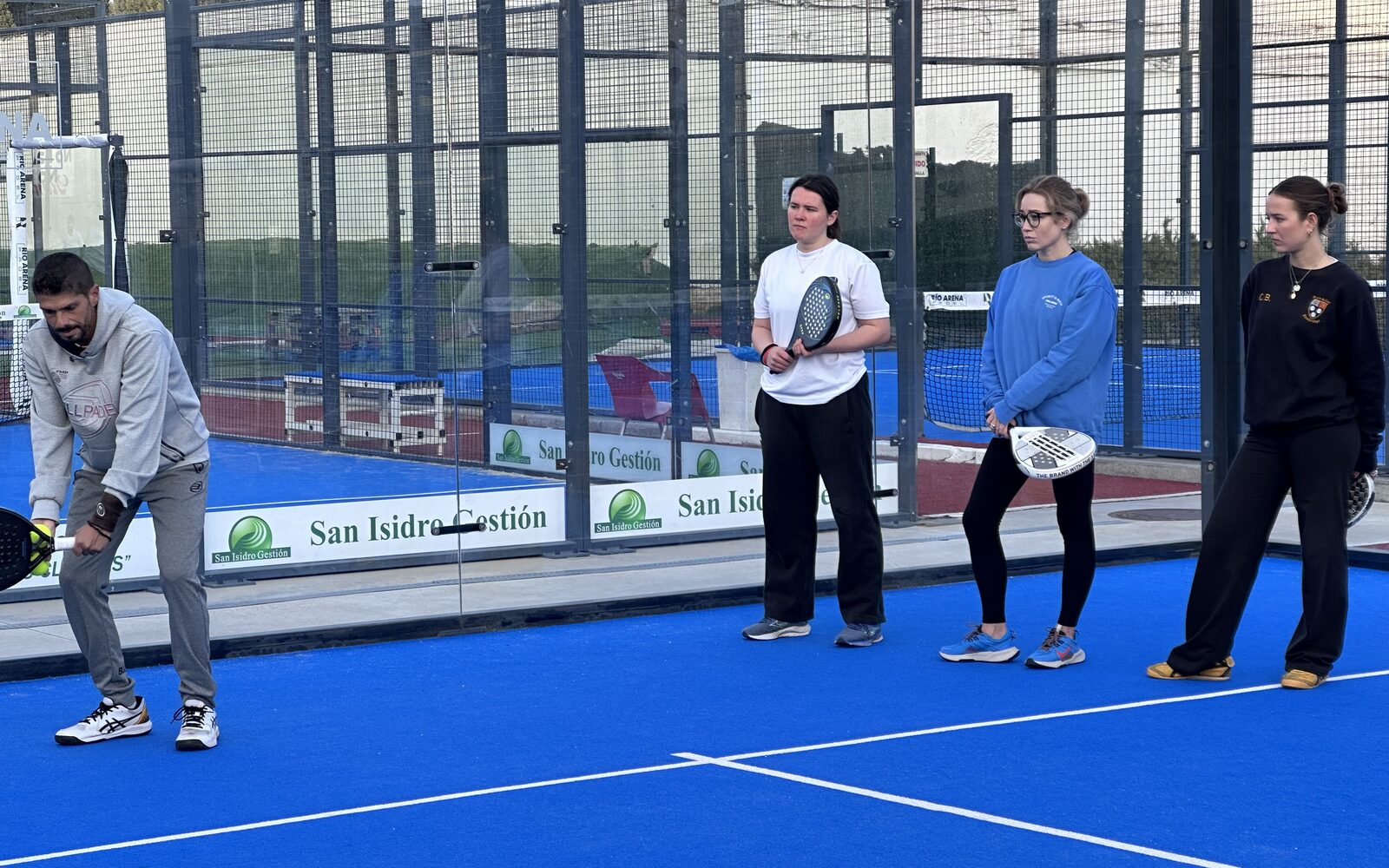 Coach teaching a small padel class in Madrid